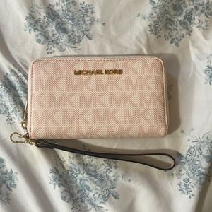 Cute and pink Michael Kors hand wallet with wrist strap!